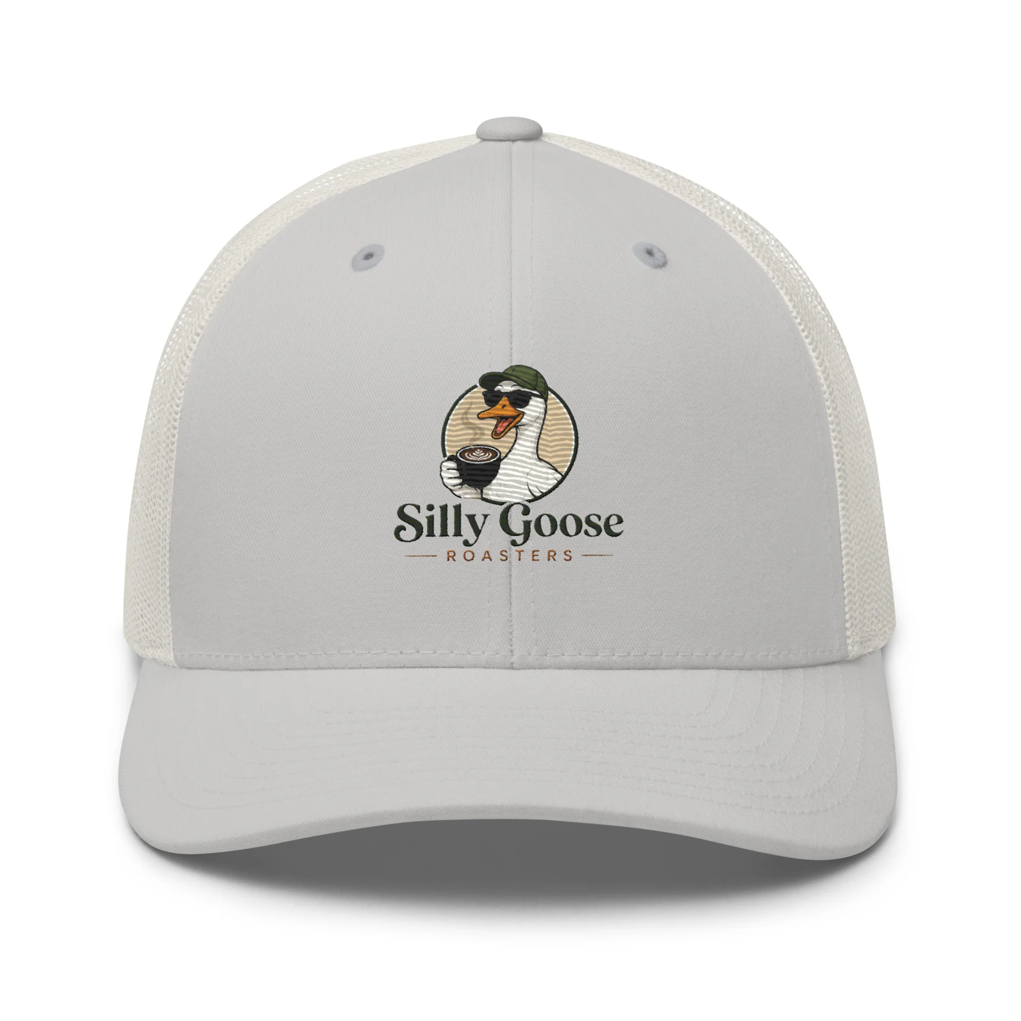A light gray trucker hat with a mesh back is displayed against a white background. The front of the hat features a circular logo with a cartoon goose wearing sunglasses and a green hat, holding a coffee cup with latte art. Below the goose logo, the text "Silly Goose ROASTERS" is printed in a stylized font.