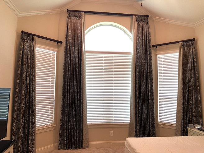 Love every corner of your bedroom with custom window treatments. The beautiful Draperies and Wood Blinds by Budget Blinds of Katy & Sugar Land in this bedroom pull the room together and bring a touch of luxury.
