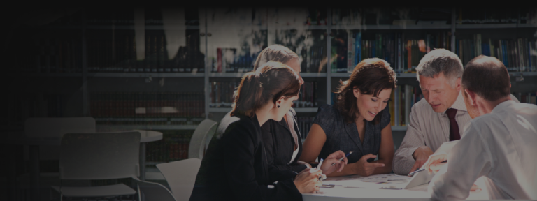 Group of advisors collaborating closely around a table.