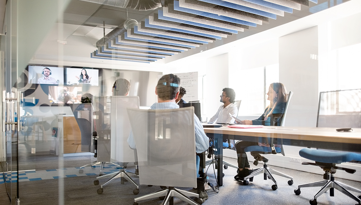 Professionals working around a boardroom table.