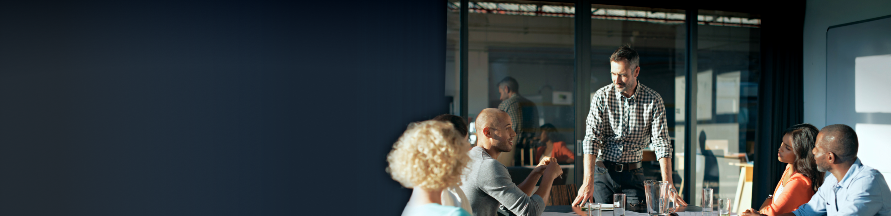 A group of professionals collaborating around a boardroom table.