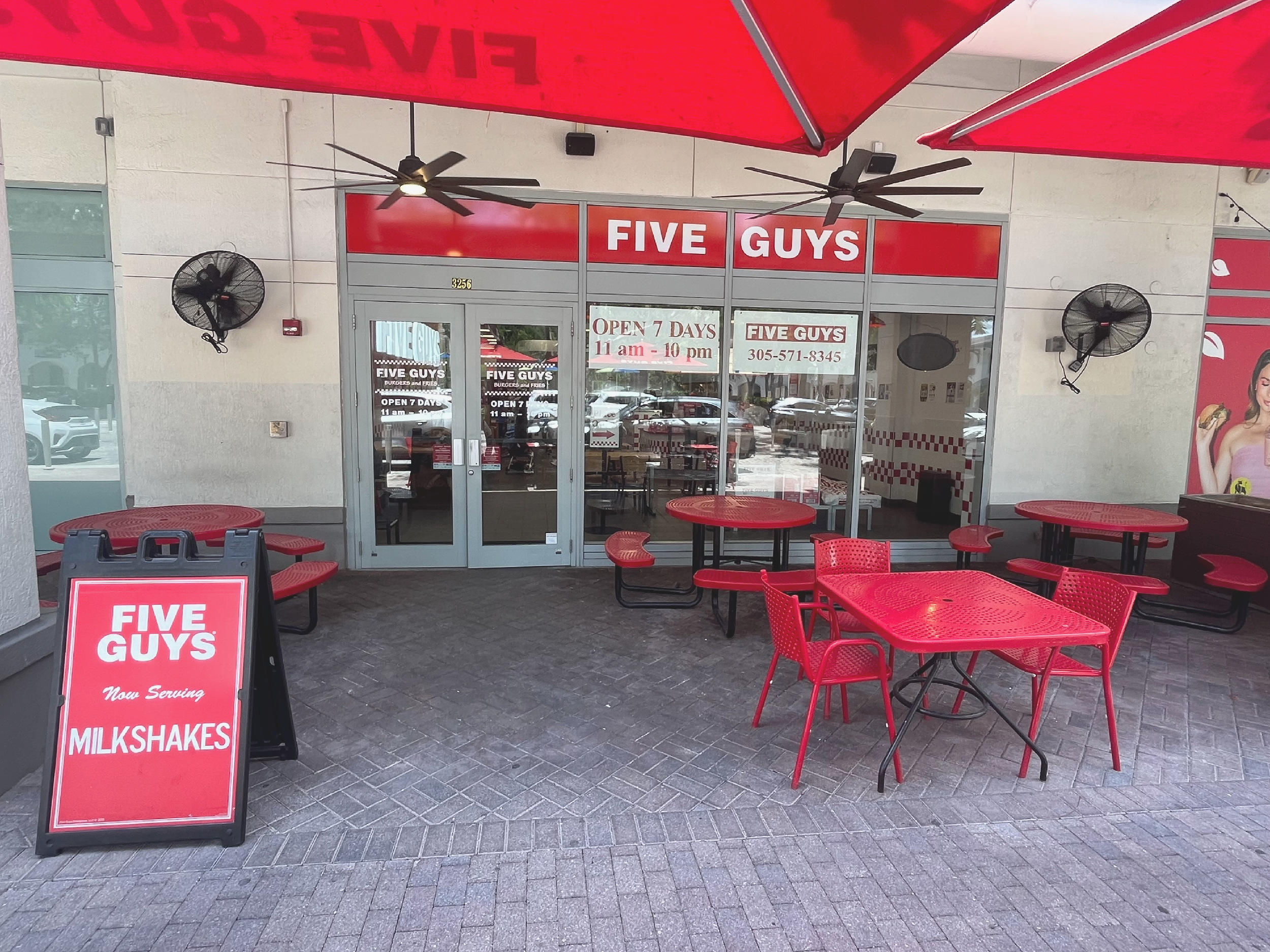 Exterior photograph of the entrance to the Five Guys restaurant at 3256 Buena Vista Boulevard in Miami, Florida.