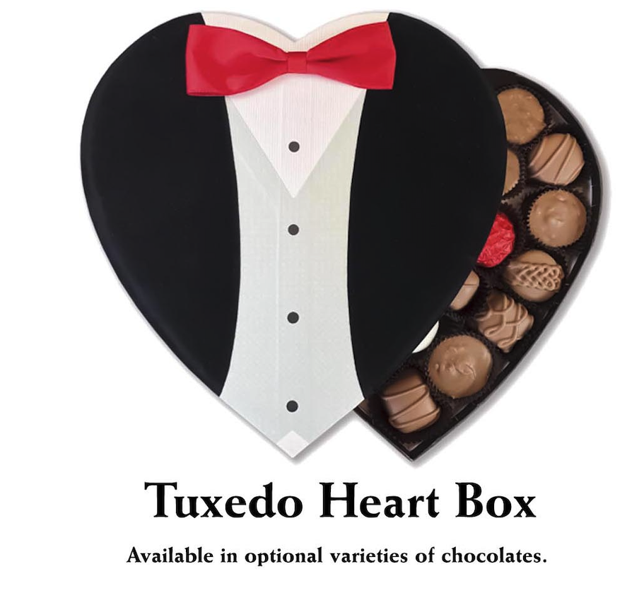 A sophisticated 24-piece chocolate box from Florence's Exquisite Chocolates in Rexburg, ID, designed for an elegant Valentine’s Day gift. The "Tuxedo Heart Box" features a stylish black heart-shaped lid designed to resemble a tuxedo, complete with a white shirt, black buttons, and a red bow tie. Inside, a luxurious assortment of handcrafted chocolates, including milk chocolate, dark chocolate, and caramel-filled delights, awaits. This refined and charming presentation makes it an excellent gift for a special occasion.
