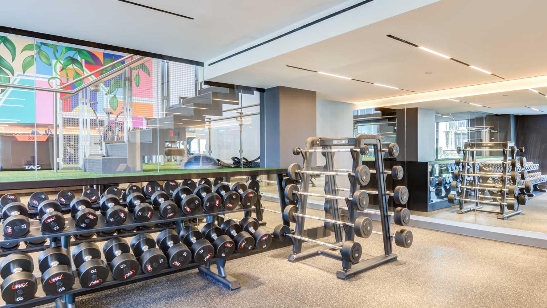 Our double-height fitness area features a custom mural to inspire your fitness goals