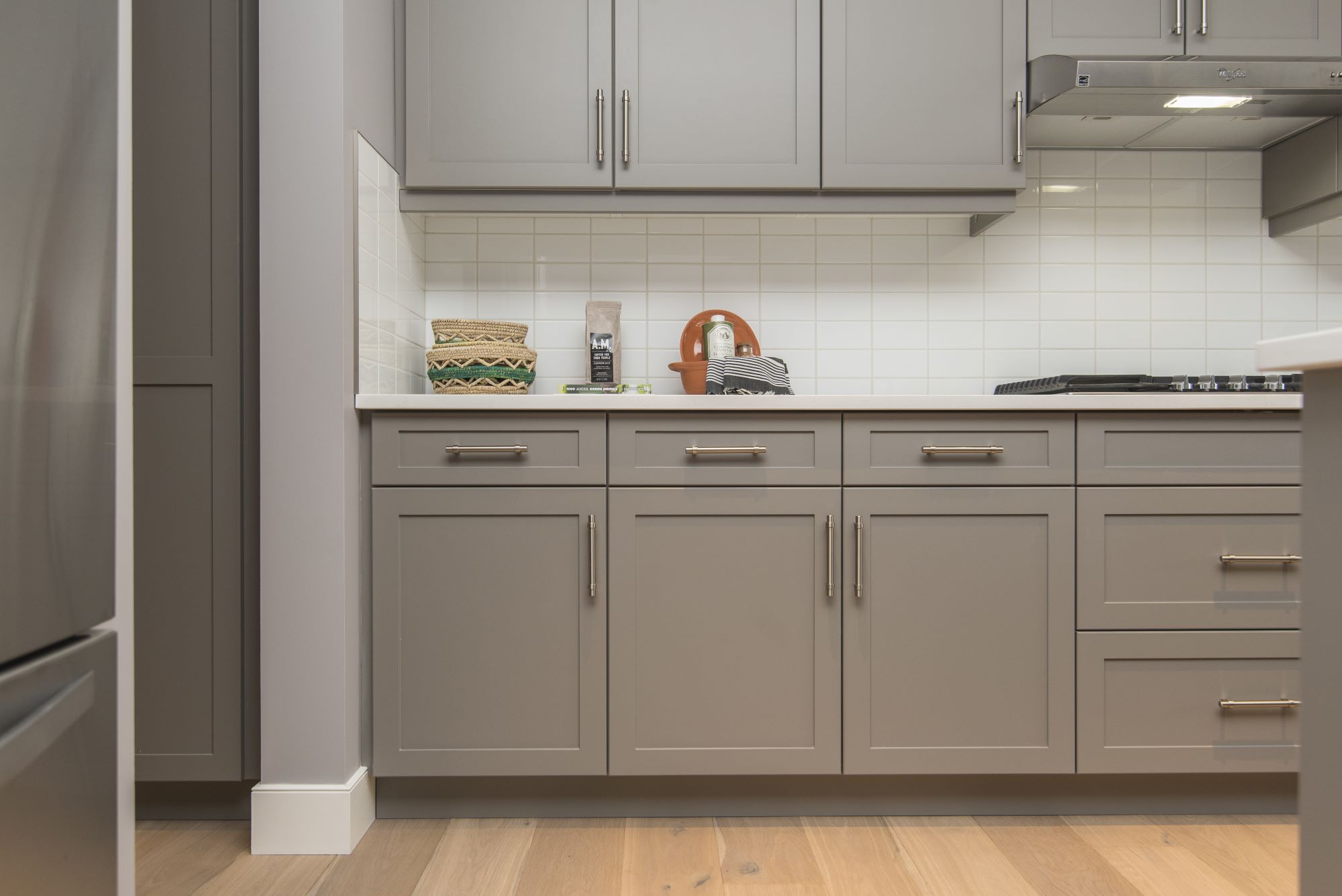 Small kitchen after cabinet painting in Cohasset