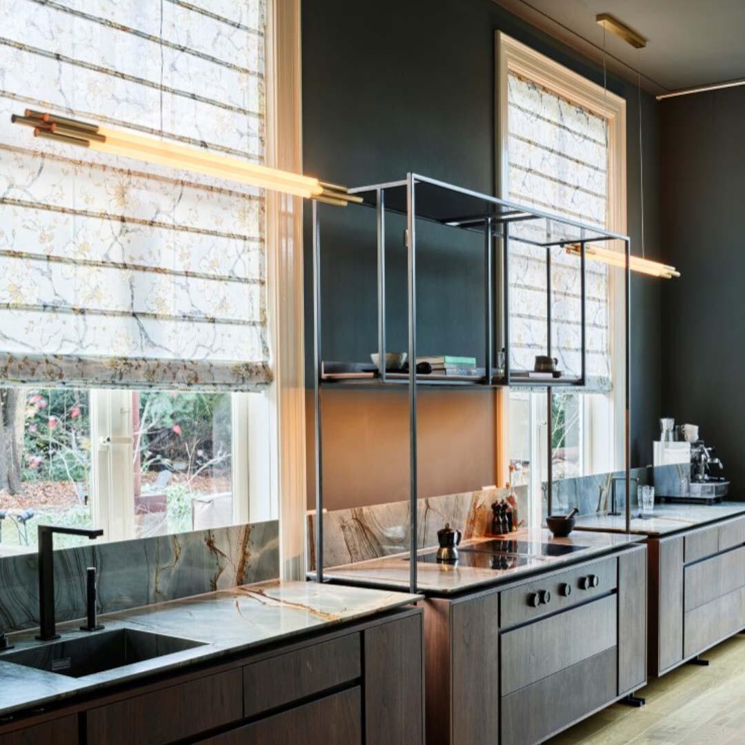 With tons of styles and fabrics, Roman shades provide plenty of options to match patterns throughout your space. Here, these shades pair beautifully with the marble countertops in this kitchen, helping achieve a more elevated and cohesive overall design.