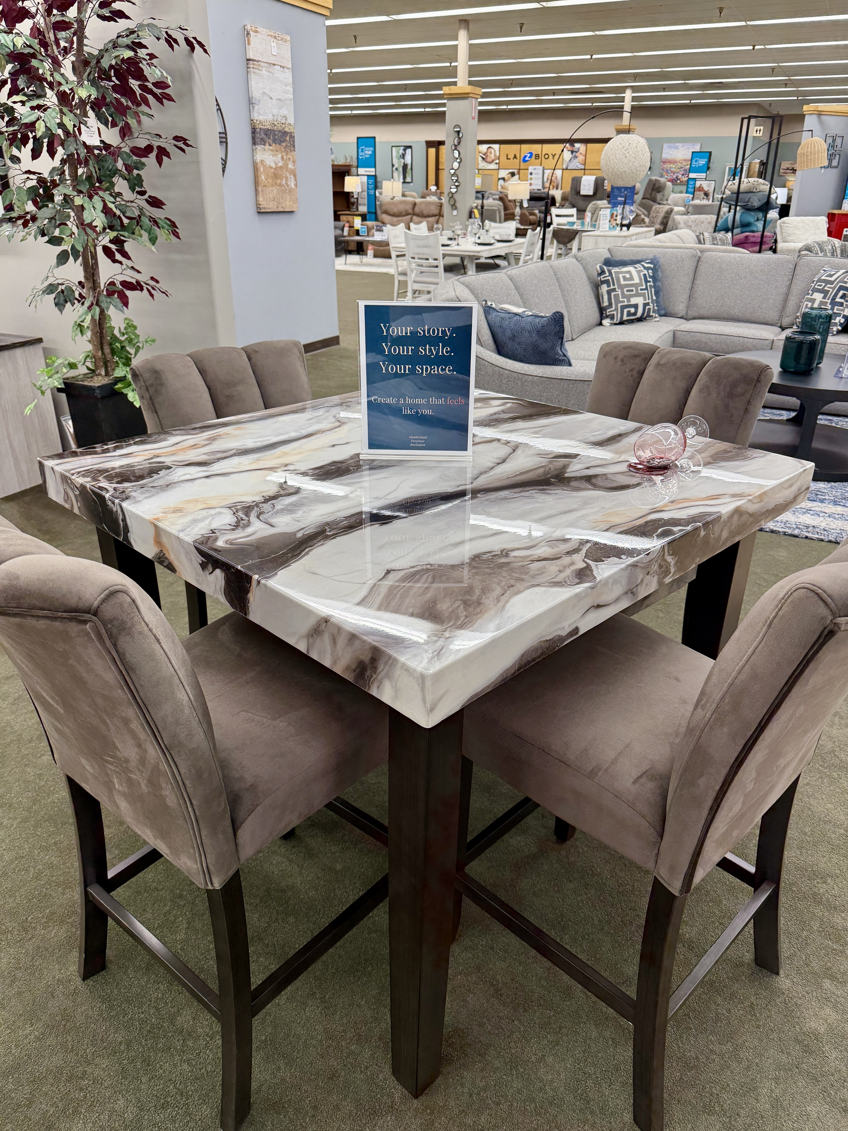 Elevate your dining space with this counter-height brown marble dining set at Slumberland Furniture Burlington. The rich marble-look tabletop and elevated seating create a stylish gathering place for meals, conversations and entertaining.