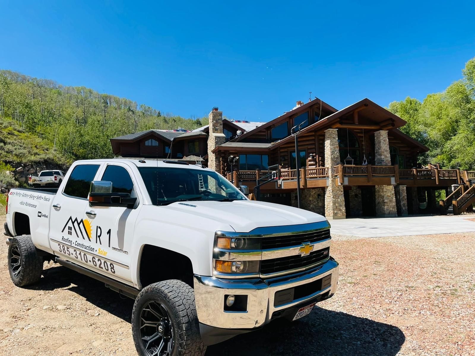 R1 Roofing & Exteriors service vehicle at a high-end roofing project in Arizona