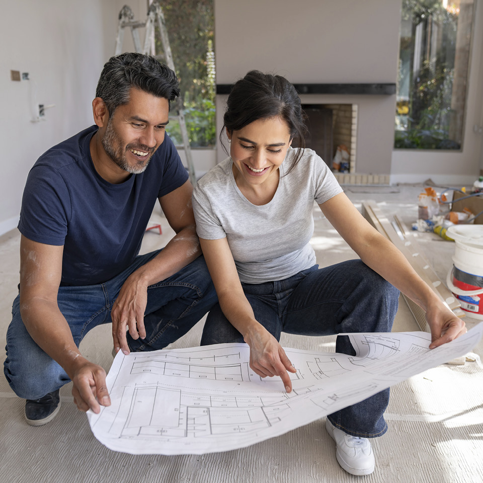 Two people looking at design plans.