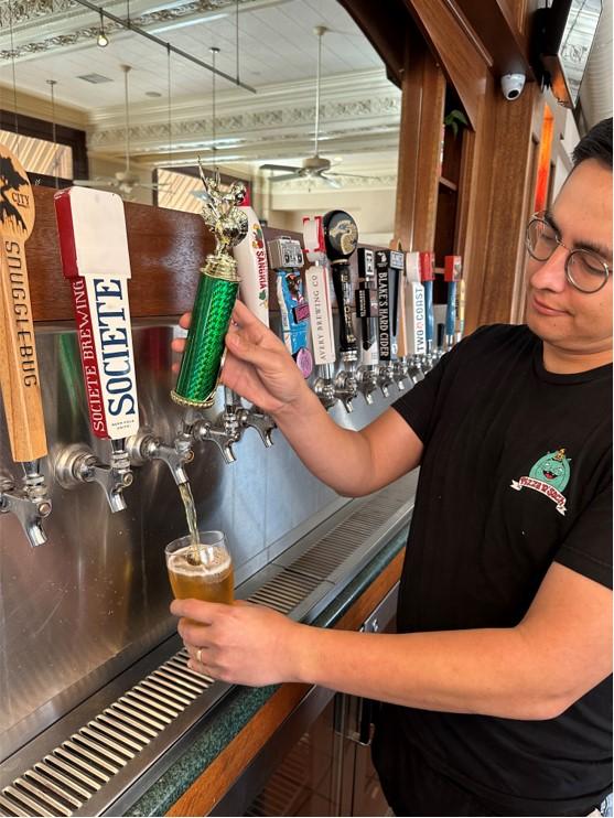 Pouring craft beer from tap at Pizza N' Such in Claremont