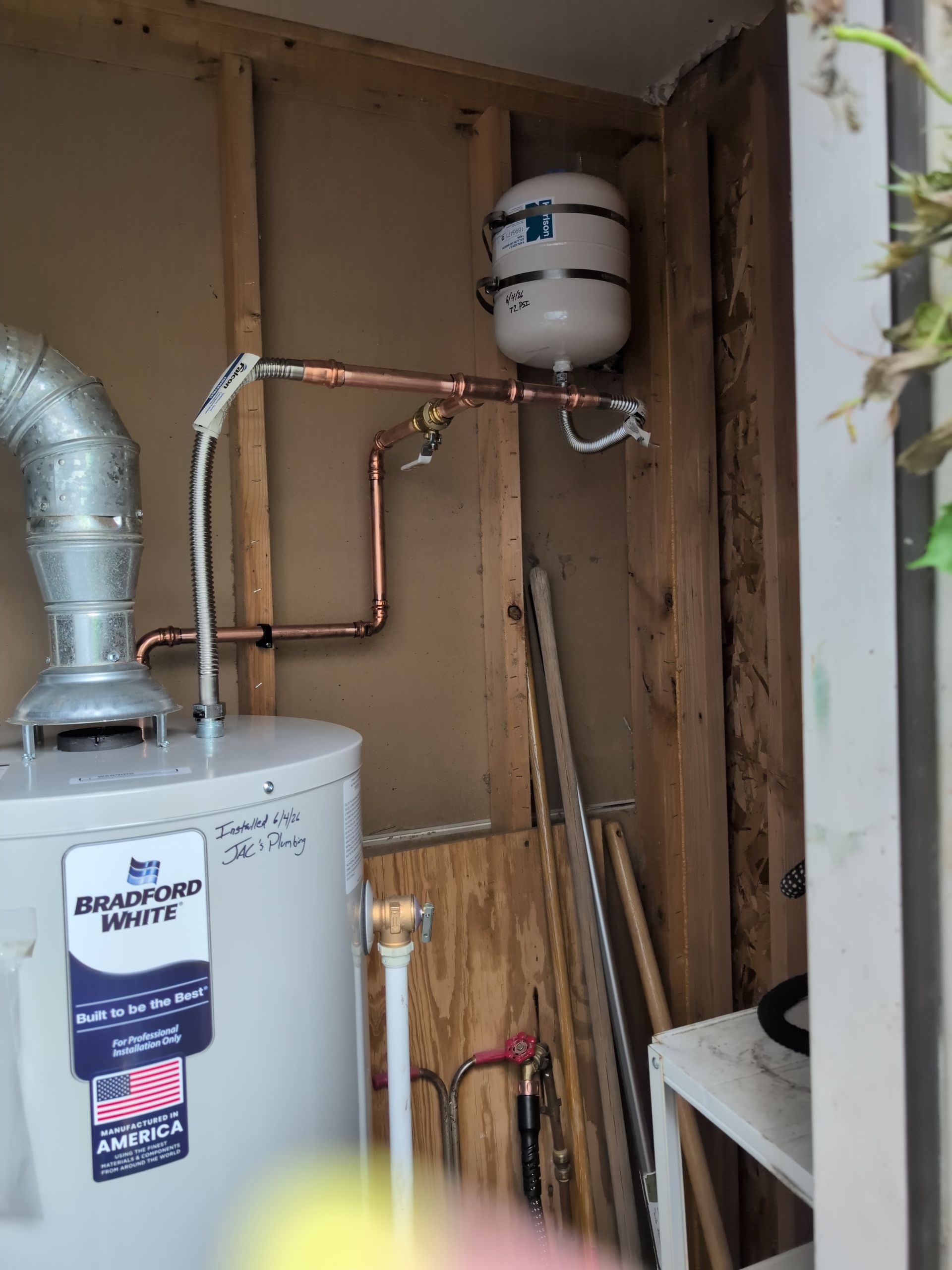 Tank water heater installation includes copper piping, flexible connectors, expansion tank, vent pip 