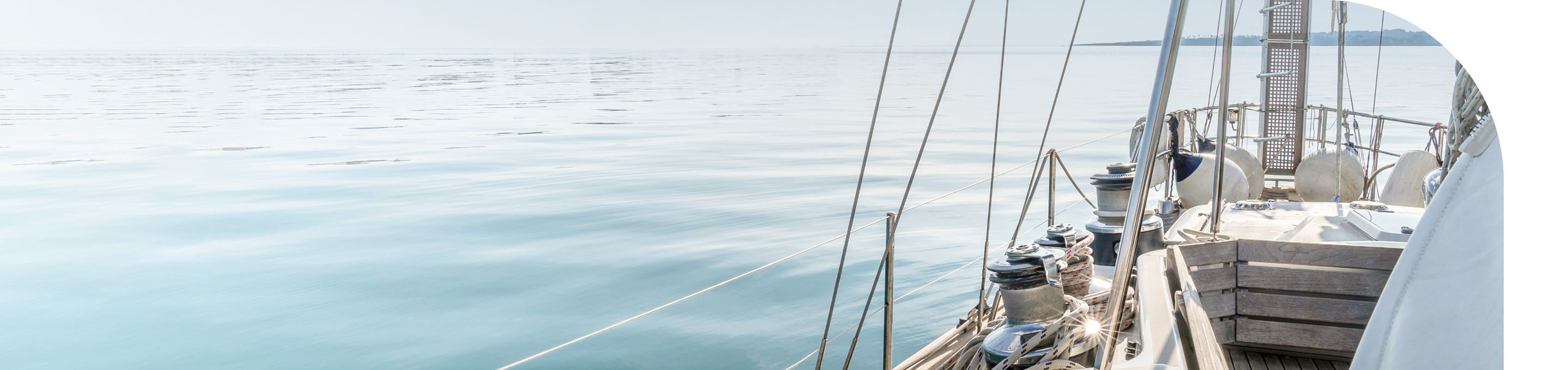 A sailboat on a calm body of water.