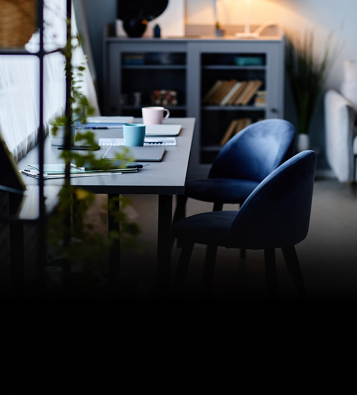 A home office desk with covered with documents.
