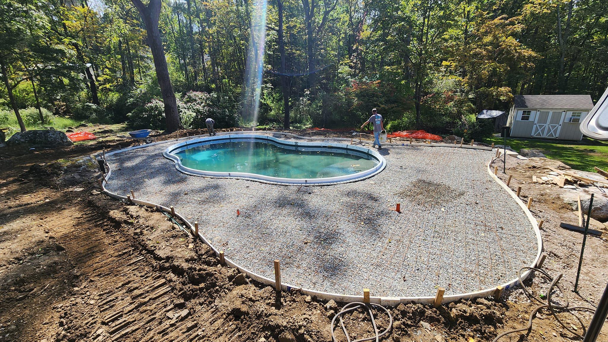 Concrete patio installation around the pool