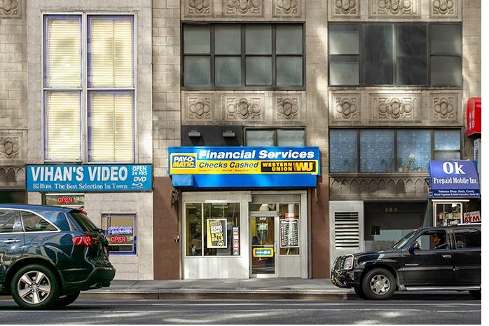 Exterior view from street of PAYOMATIC store located at 590 Eight Ave New York, NY 10018