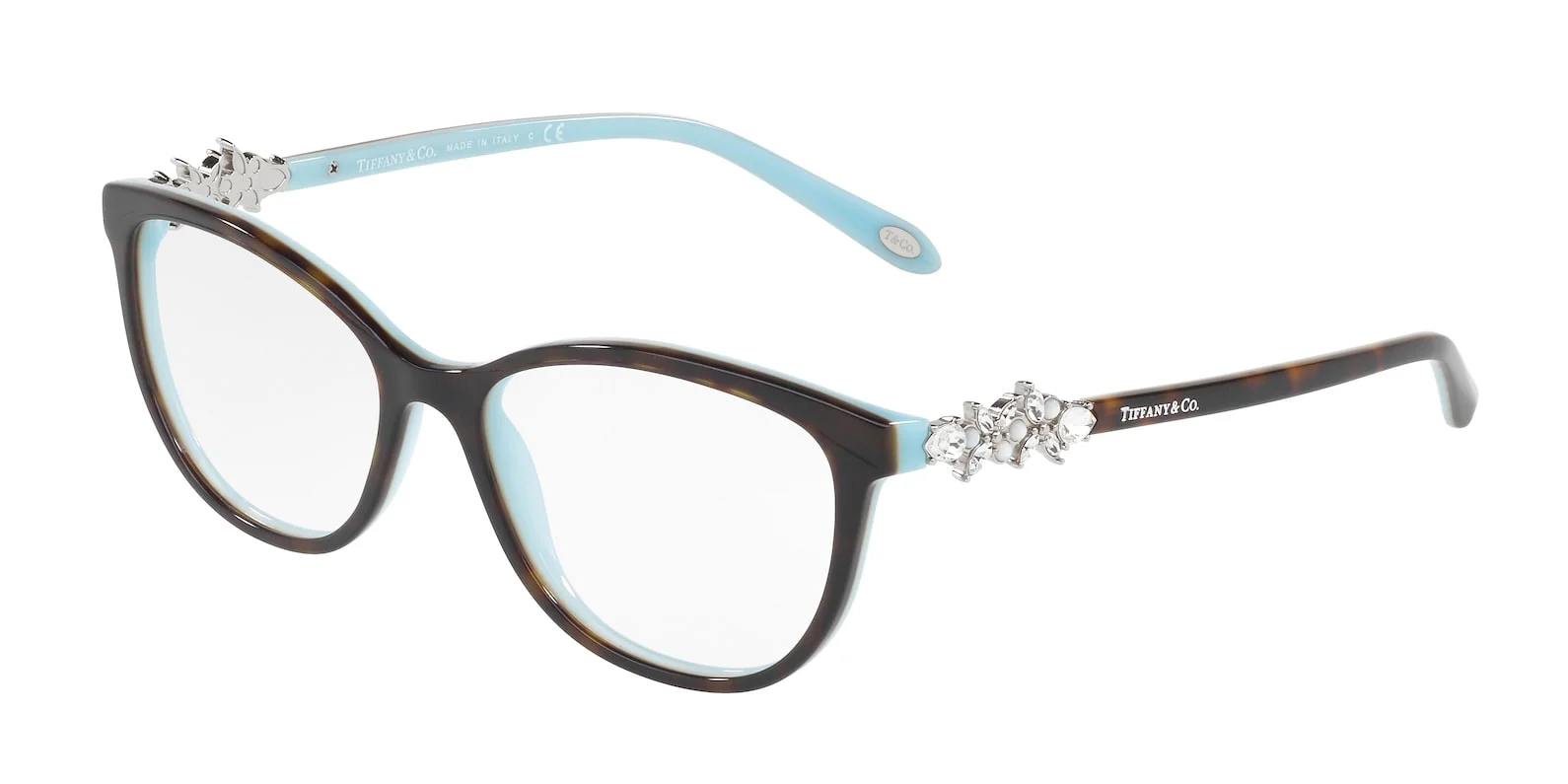 A pair of brown tortoise shell cat-eye glasses with light blue interior and decorated temples with crystals and pearls. The Tiffany & Co. logo is visible on the right temple. The glasses are photographed on a white background.