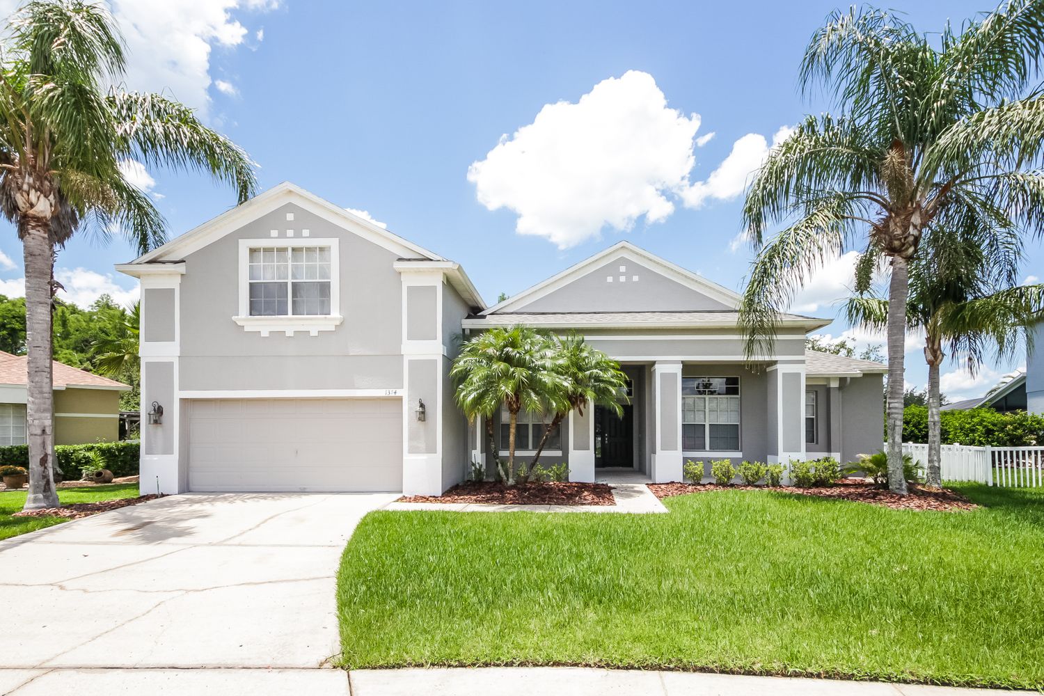 Beautiful home with a two-car garage and covered patio at Invitation Homes Orlando.