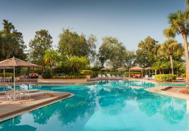 Surrounded by the tranquility of our resort-style pool, you'll forget you're near the airport.