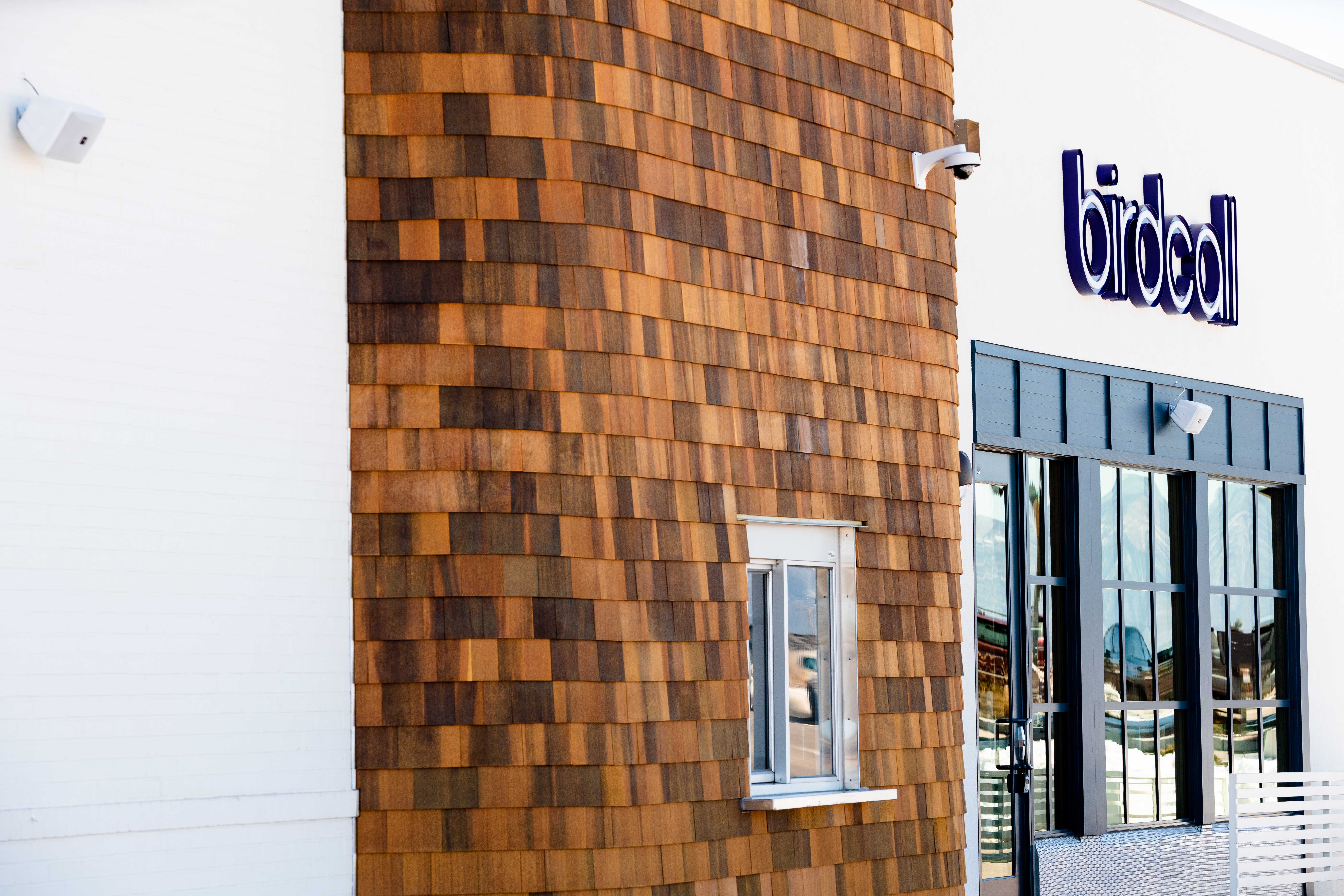 Exterior of Birdcall Colorado Springs, showing off the drive-thru window and dining room windows.