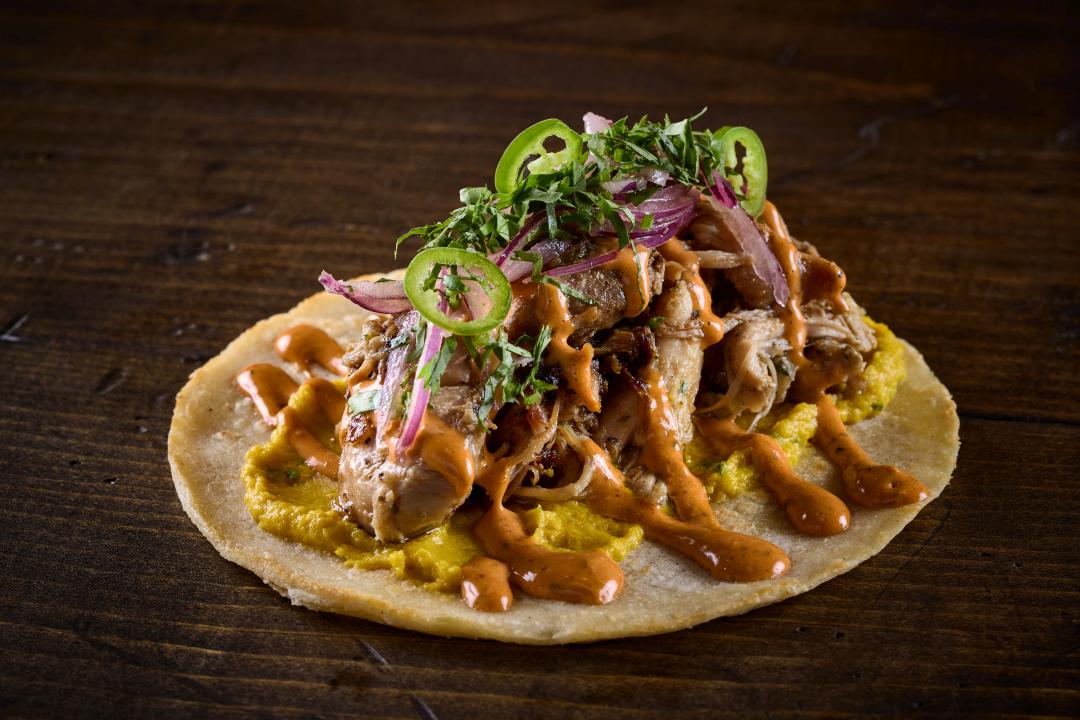 Doña Rosi taco nuestro with Peruvian Chicken, Sweet Corn Tamale, Onion Salad, Anticucho Aioli, found at Taco Bamba's Sterling location.