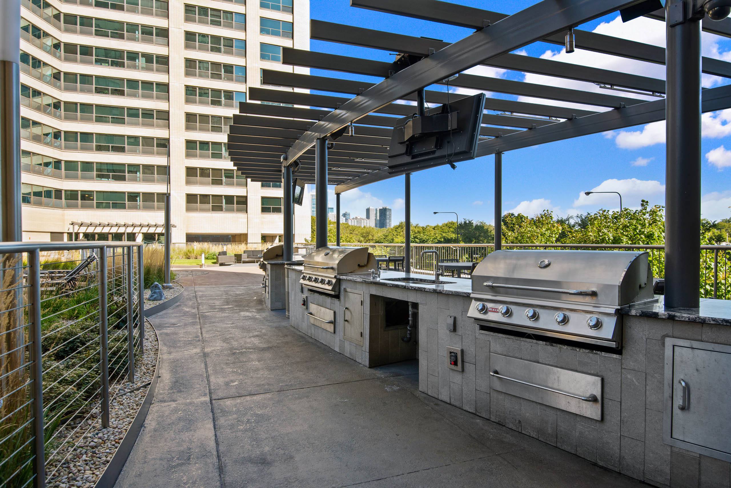 Rooftop grilling station with builtin barbecues and pergola 