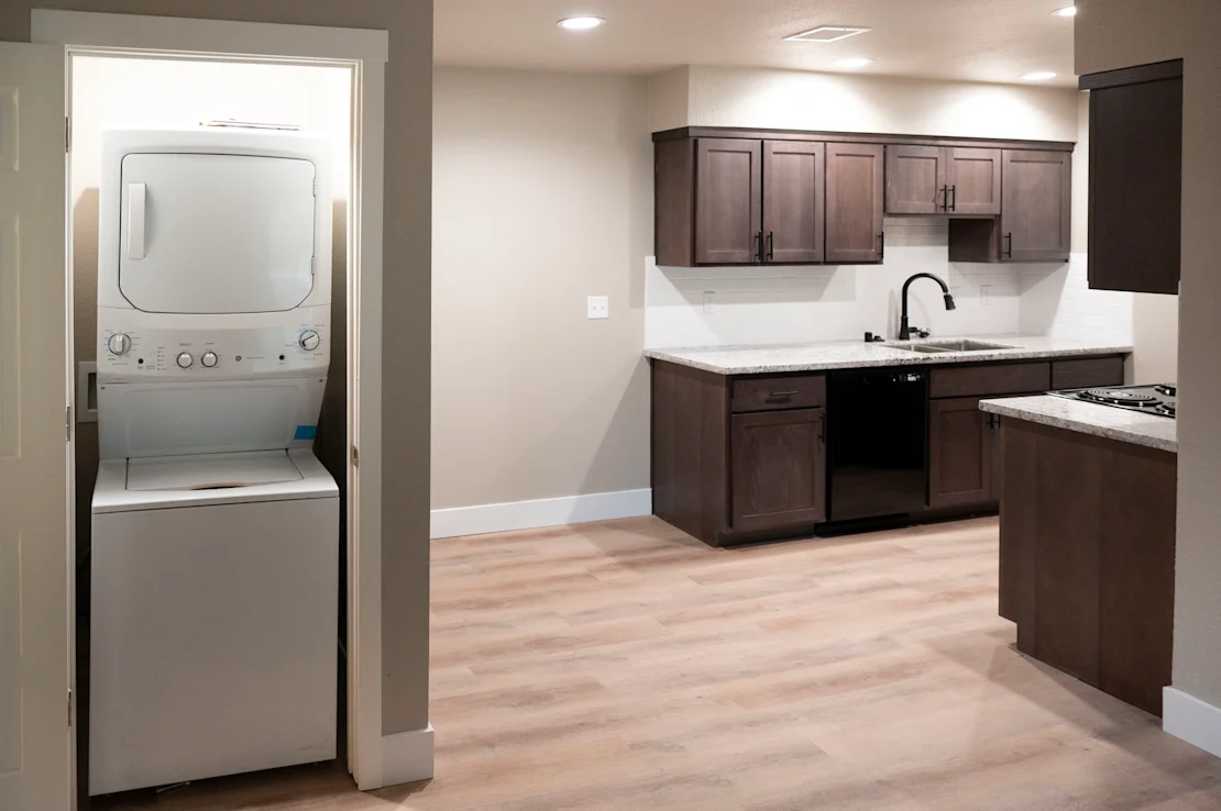 A modern kitchen with a white oven and wooden cabinets