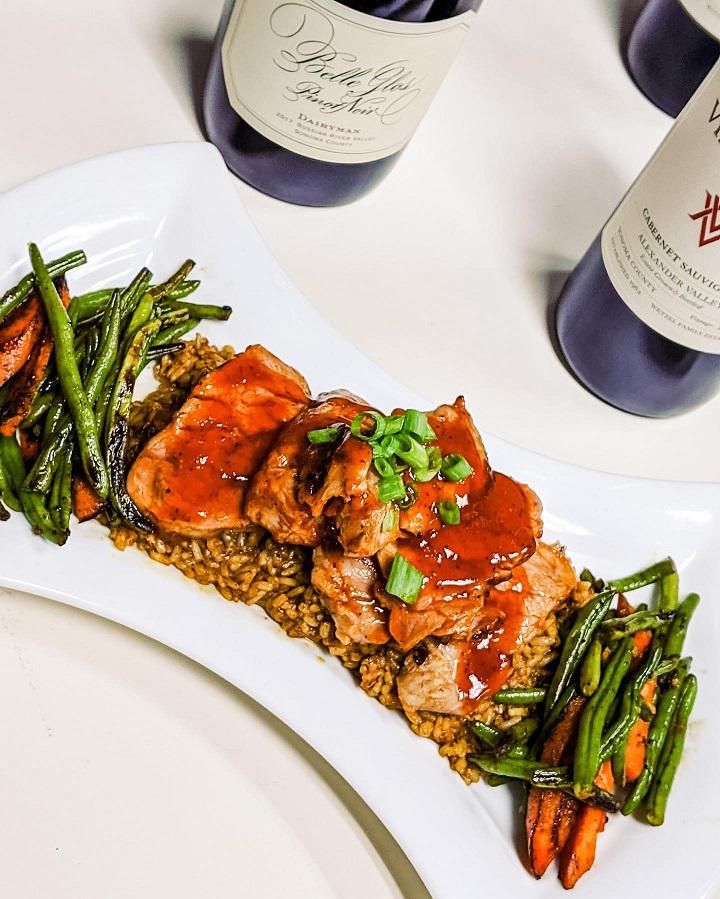 Sweet & savory barbecue pork tenderloin served over dirty rice & mixed veggies!