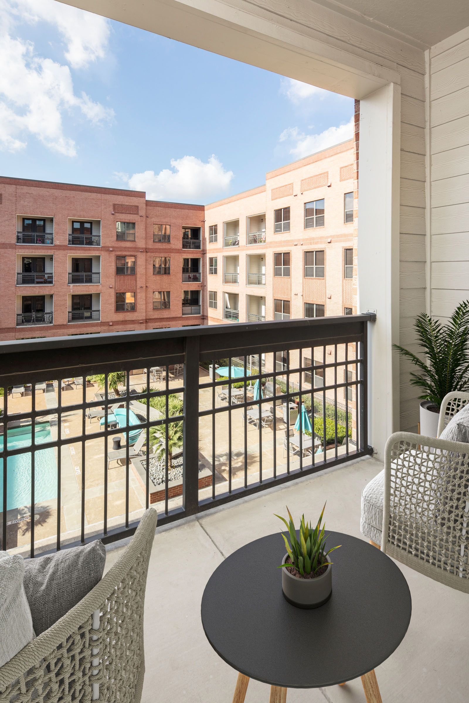 Balcony overlooking the resort-style pool at Camden Travis Street Apartments in Midtown Houston, Tx