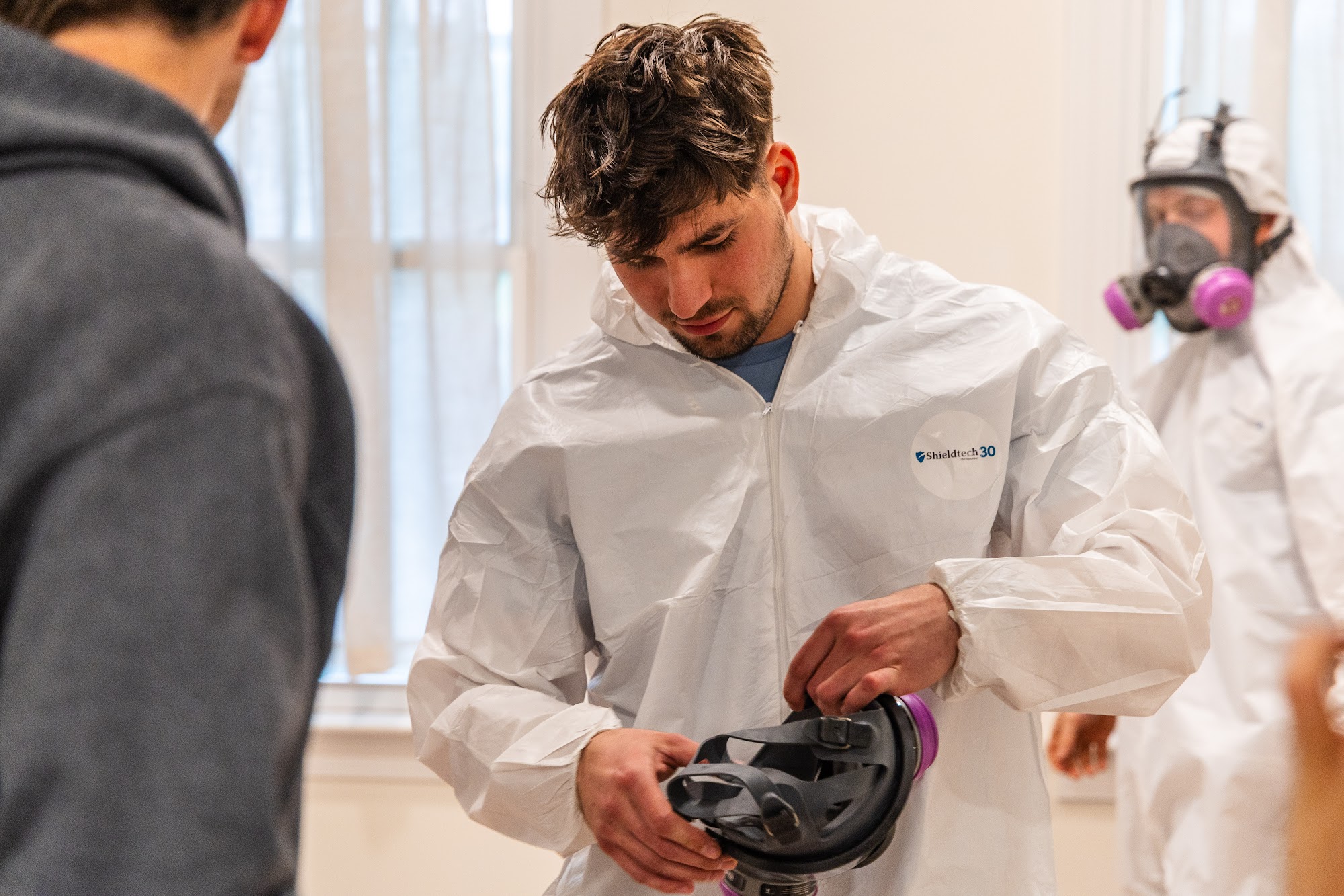 A CT Mold Remediation Specialists technician suits up in protective PPE before beginning safe mold r 