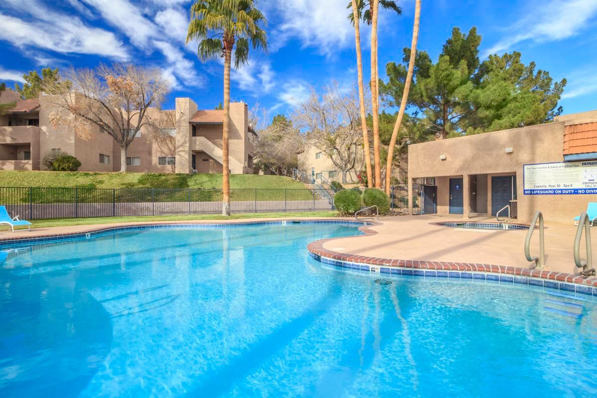 Shimmering blue swimming pool with palm trees
