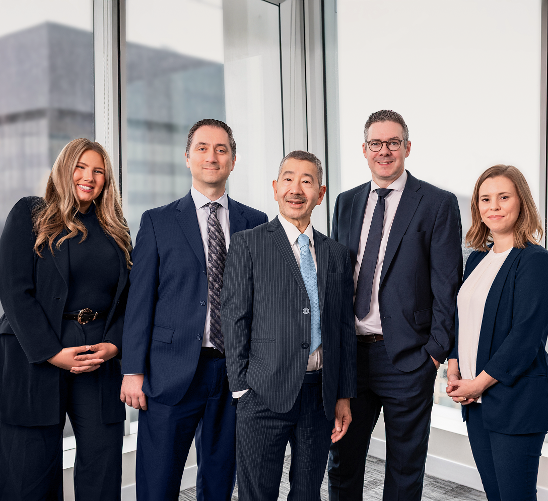 The Yamamoto Wealth Management Group standing side-by-side in their office.