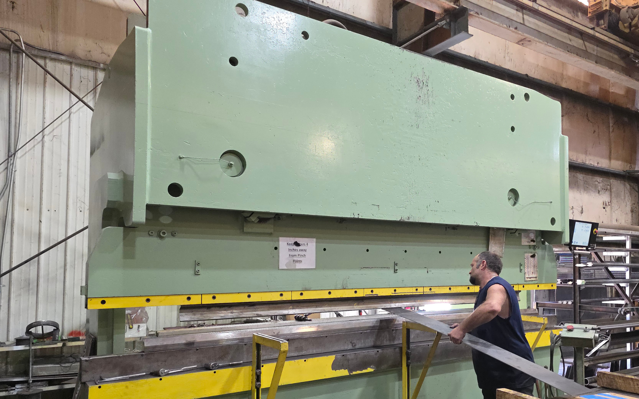 Heavy-duty press brake operation at Ozark Mountain Steel, allowing for precise bending and forming of sheet and plate steel. This equipment enables custom fabrication for structural components, buildings, and specialty metal projects.