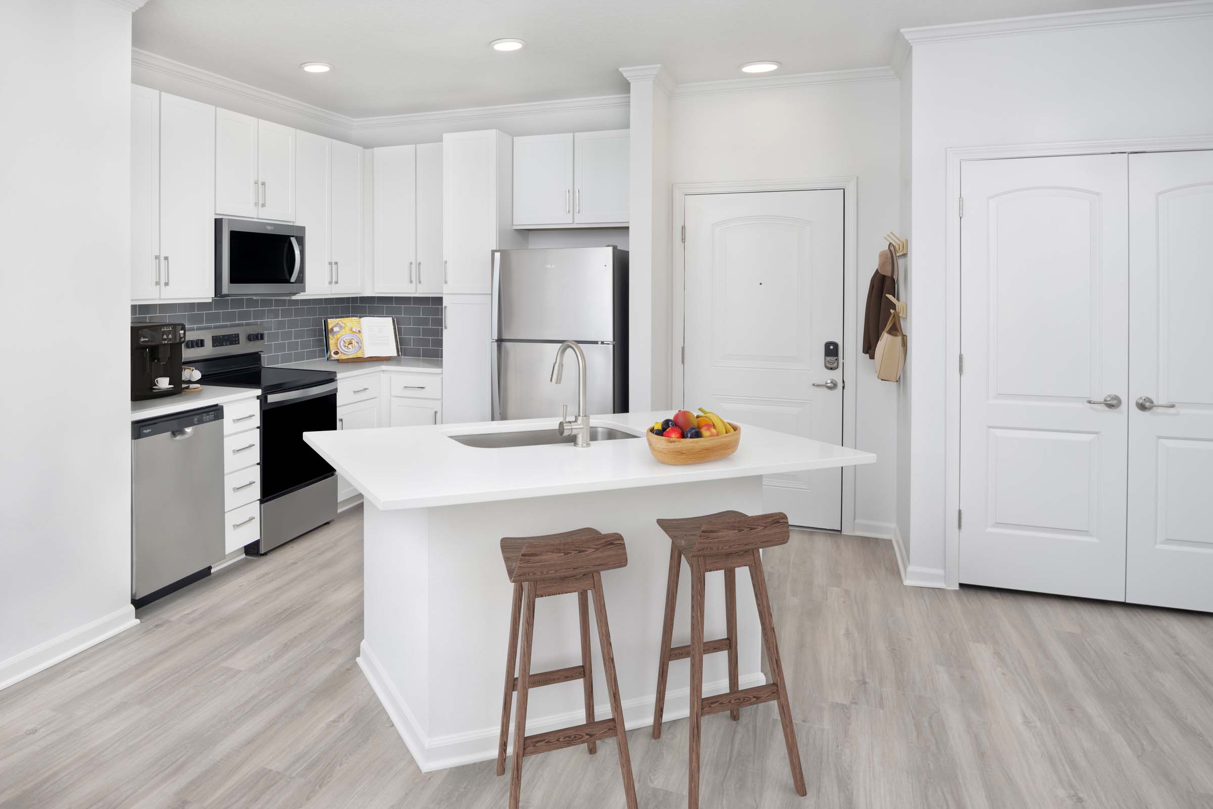 Kitchen with island and stainless steel appliances at Camden Montague apartments in Tampa, FL