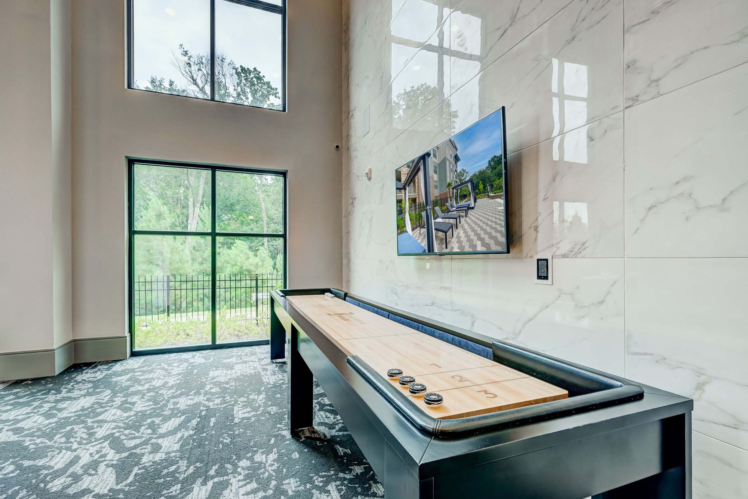 Shuffleboard table in the resident lounge at Camden Alpharetta apartments in Alpharetta, GA