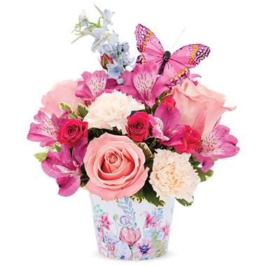 Make her heart flutter with this cheerful galvanized pot adorned with a butterfly pattern. Pink roses, purple alstroemeria, peach carnations and blue delphinium make a stunning arrangement only she will love!