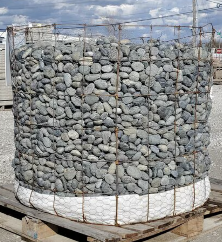Palletized Mexican Beach Pebbles Black 1 - 2 in. Easy-to-Handle Palletized Convenience. Durable for Long-lasting Beauty. Durable Mexican beach pebbles resist fading and wear. Achieve a modern and sleek look with our Black Mexican Beach Pebbles. As naturally rounded beach pebbles, the edges of these attractive stones have been worn smooth by the pounding ocean surf. Their charcoal gray color adds a touch of sophistication to gardens and landscapes. Ideal for gardens, dry creek beds, water features, and more.