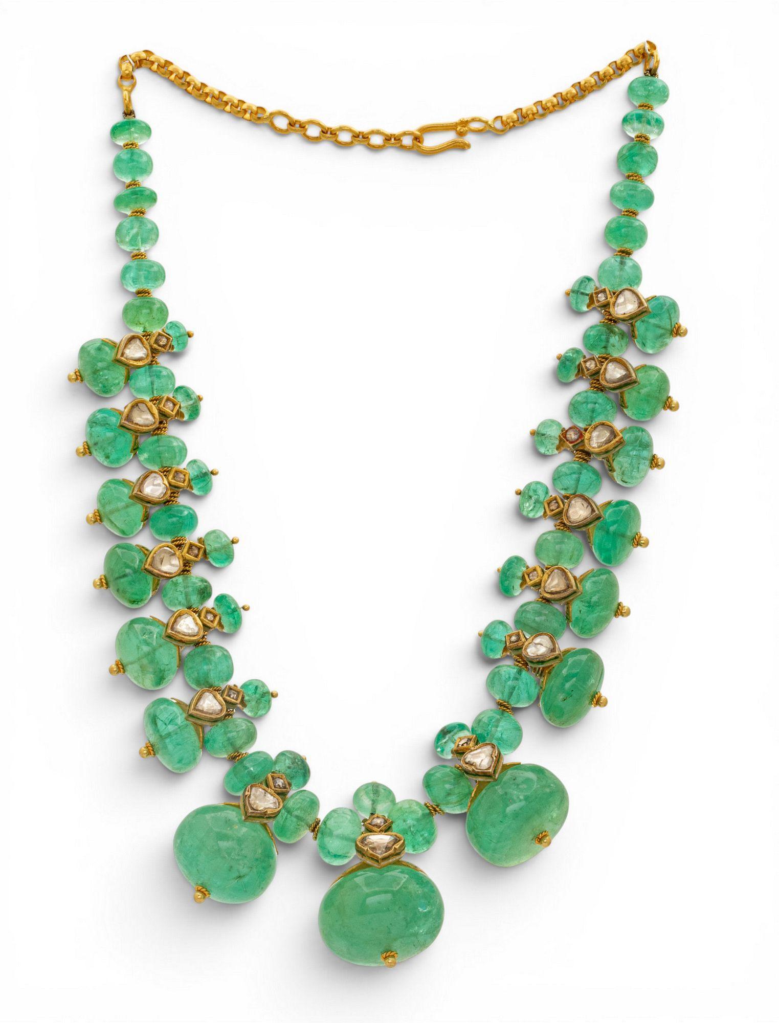 green ncklace on a gold chain