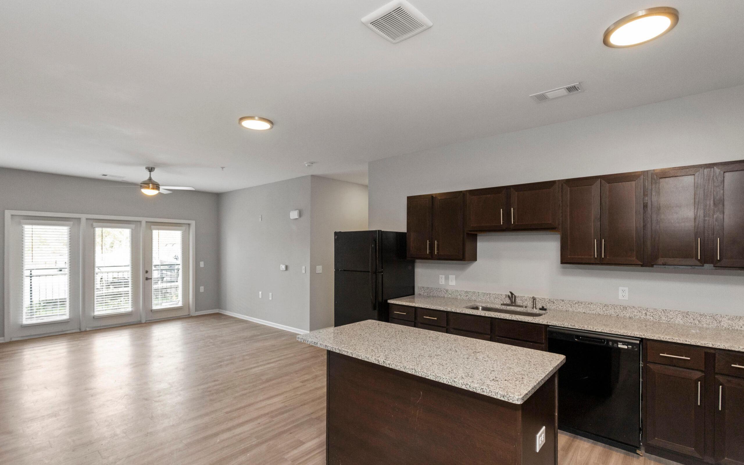 Spacious open floor concept kitchen with wood grain plank style flooring