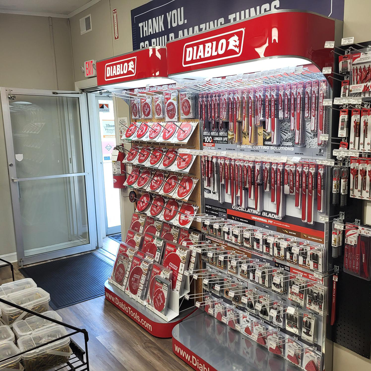 Interior storefront display featuring a Diablo tools branded end cap stocked with circular saw blades, oscillating blades, and bi-metal cutting accessories, positioned near the store's glass entrance doors.