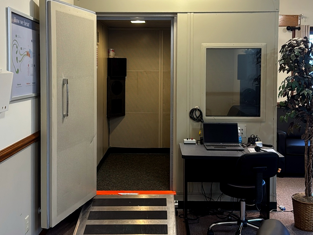 Interior photo of the hearing testing booth in the AudioNova hearing clinic in Fort Wayne, IN