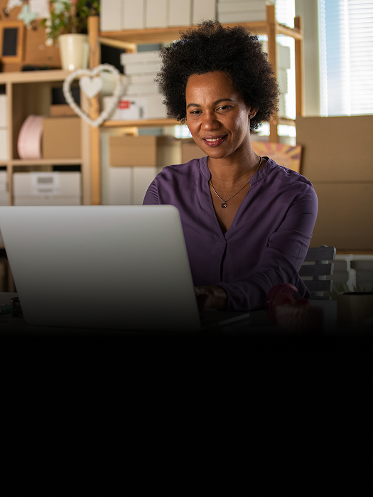 A woman working in her office on the computer.
