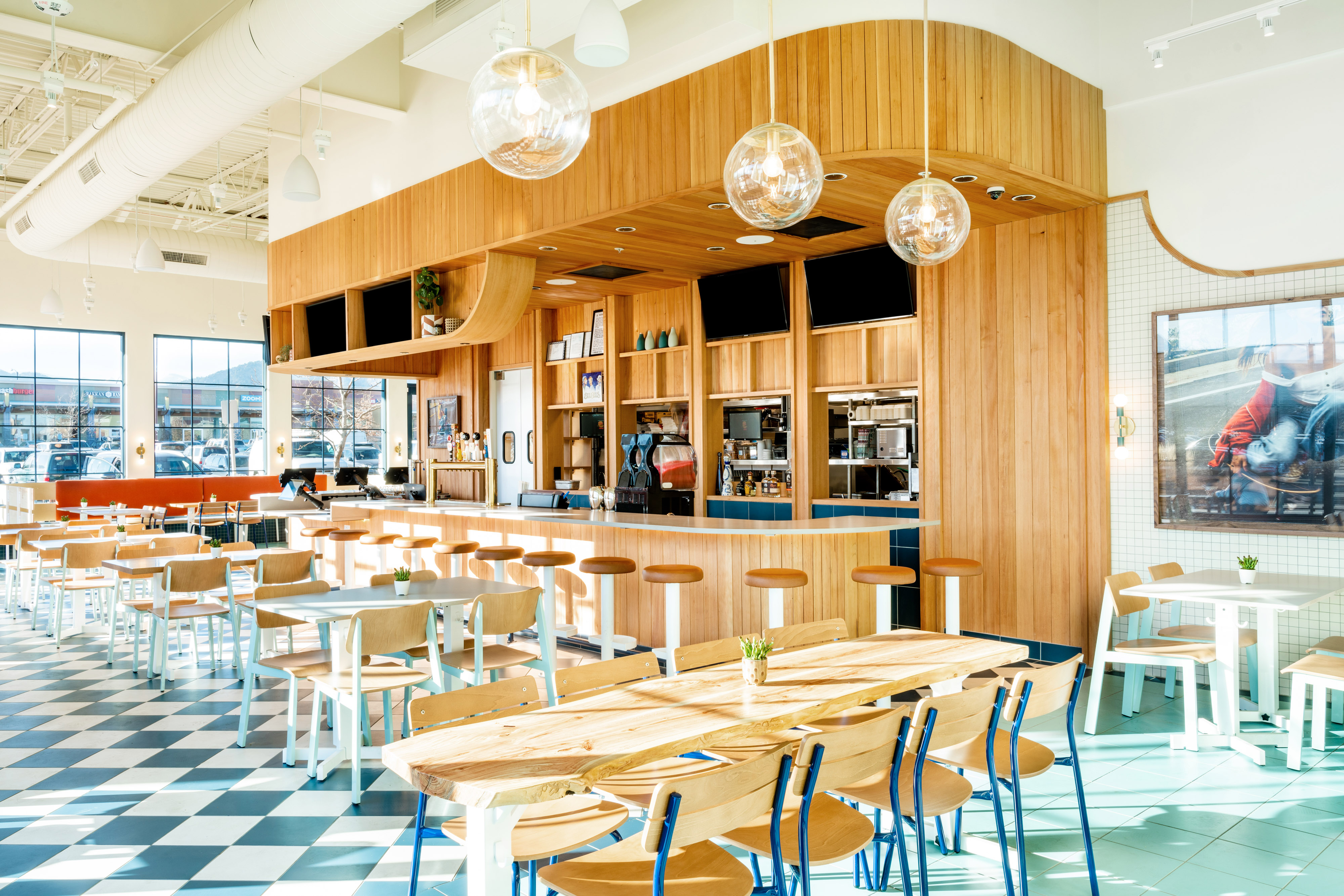Interior of Birdcall Boulder, highlighting the bar and drink offerings.