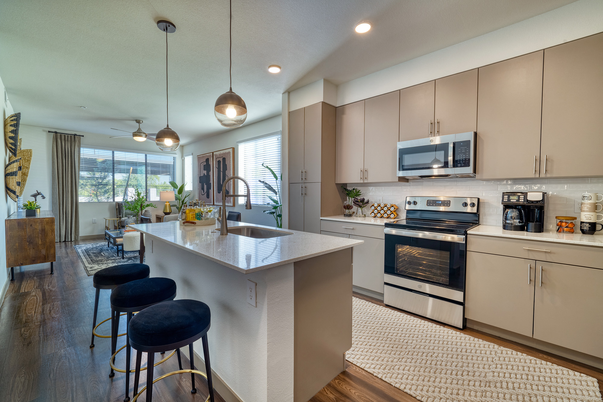 an open kitchen with an island and stools