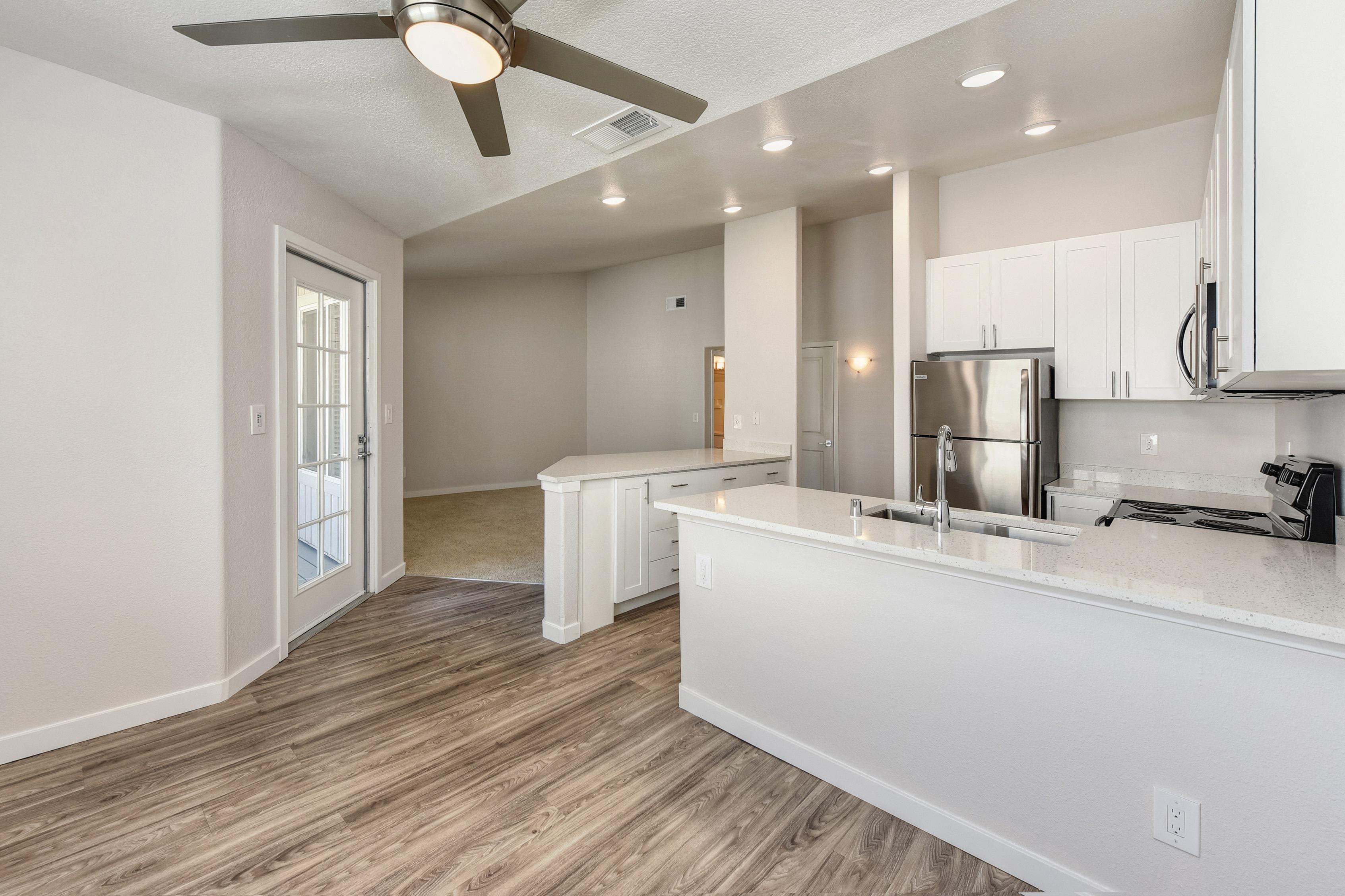 Open Kitchen with Wood Inspired Floors at The Legacy Apartments
