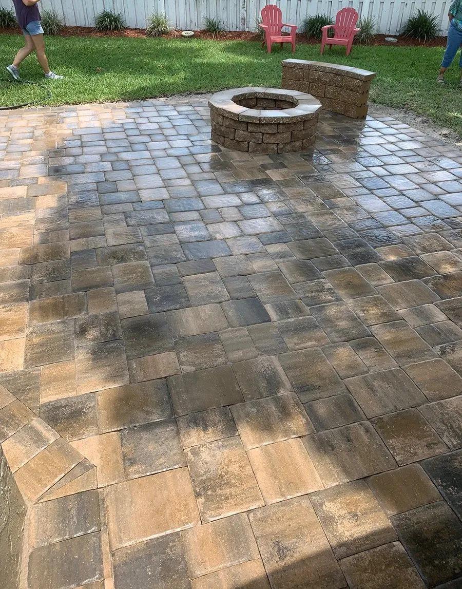 In Lakeland a homeowner asked for a designed paver open patio with a firepit and custom bench seat