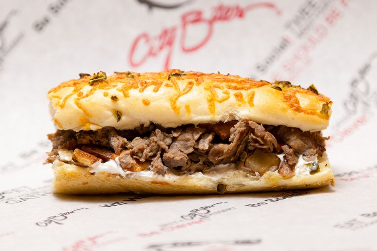 Beefeater Sandwich at City Bites across the OKC metro area. Grilled sirloin steak, melted provolone, grilled potatoes, sour cream, salt & pepper.