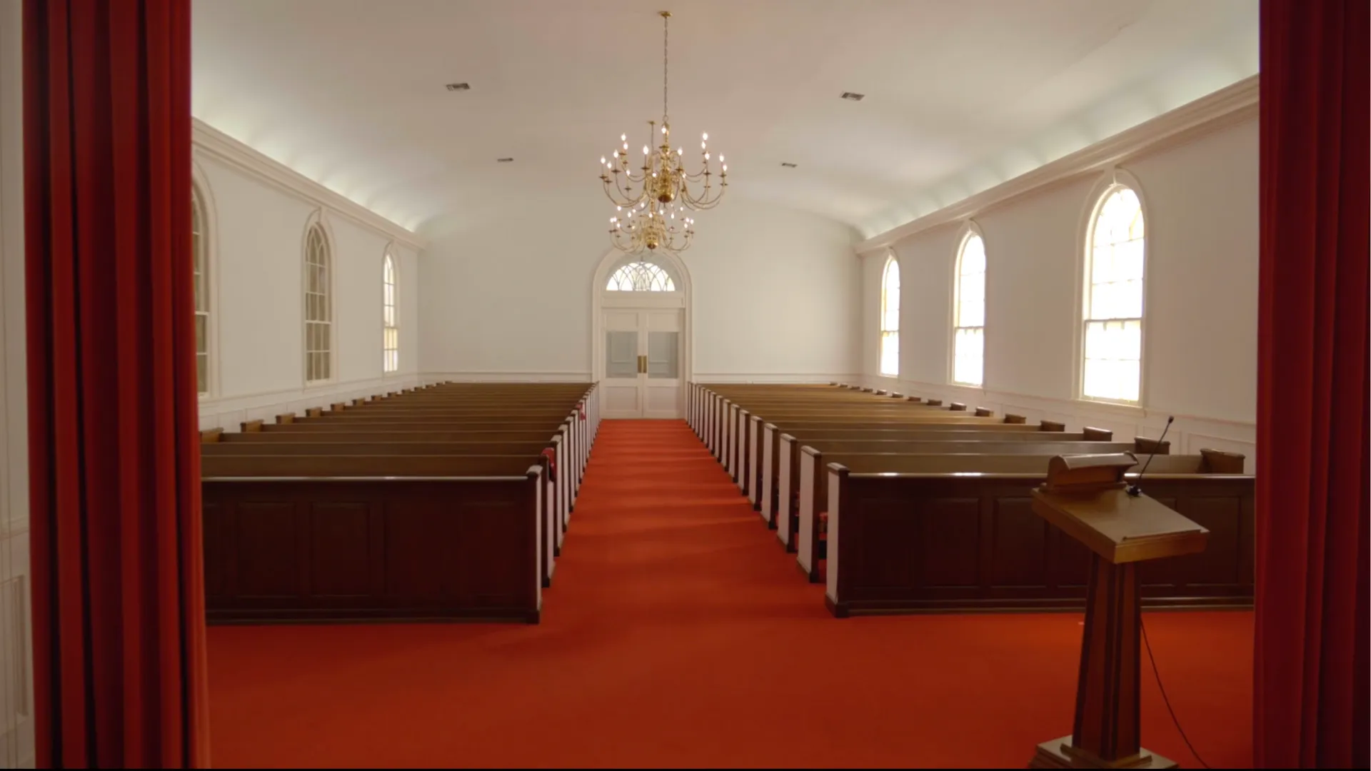 A second view of Platt's Augusta chapel, showing the pulpit and arched windows that flank the red-cu 