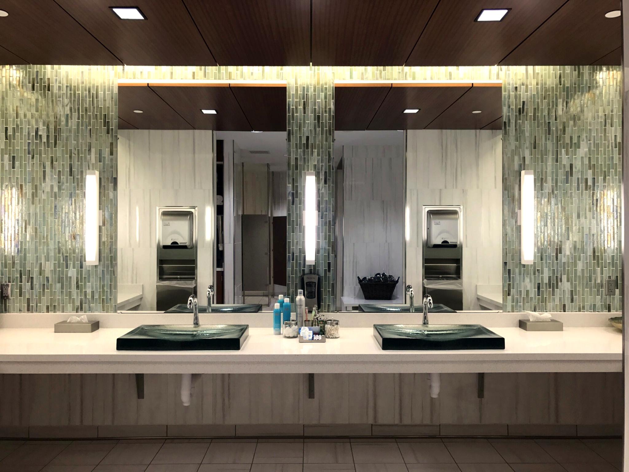 Spa vanity area with dual sinks and upscale finishes