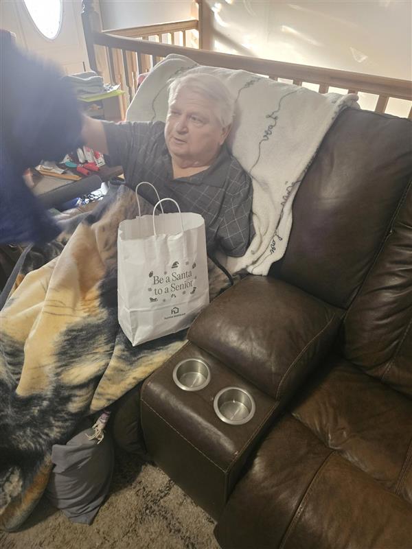 Home Instead team delivering gifts through the Be a Santa to a Senior program to support older adults.