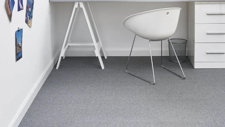 Grey carpet tiles in a white room with modern white office furniture